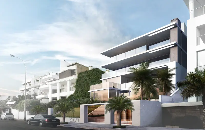 Render del edificio Rocat desde la rambla: losas blancas en voladizo, frentes de vidrio y palmeras en el jardín de acceso